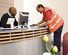 Postman picking up mail from office