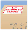 Close-up of return-to-sender sticker on envelope