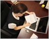 Person reading paper at desk