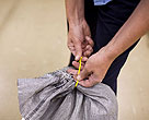 Person tying up bag 