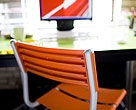 Orange chair and monitor