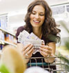 Woman in supermarket holding vouchers