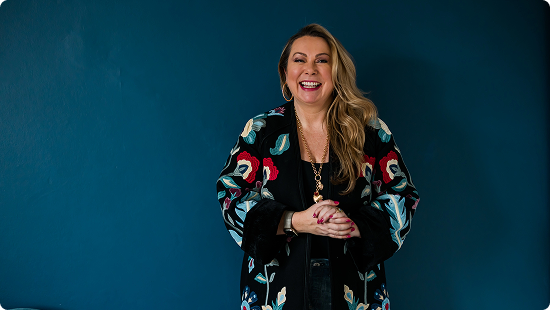 woman smiling in front of a background
