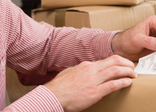 Customer sticking a label to a parcel