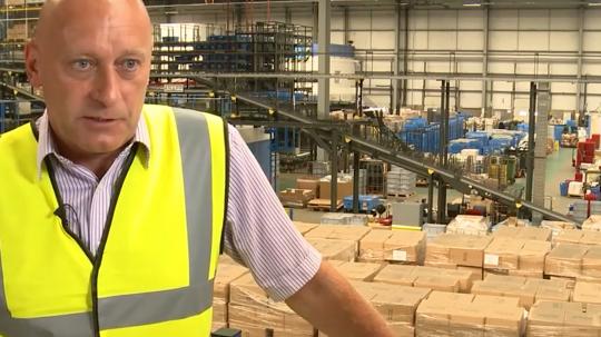 A man standing in a a warehouse
